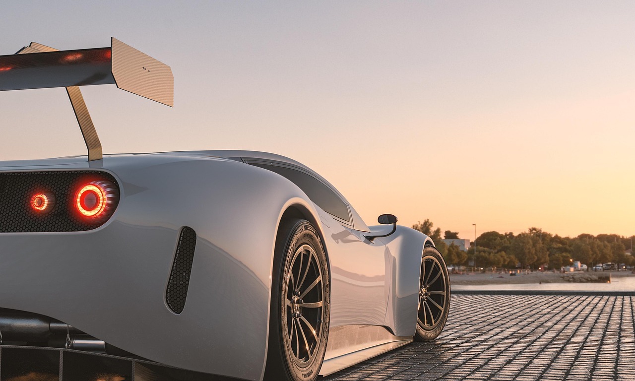 high-performance supercar parked on a waterfront plaza at sunset.